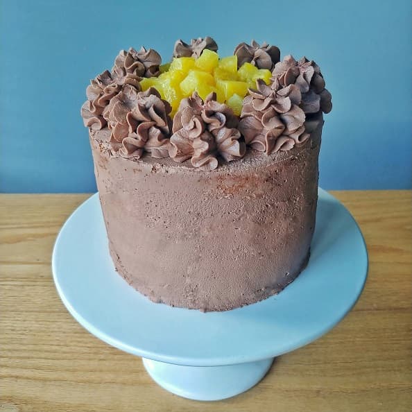 Chocolate pineapple gateau cake on a cake stand