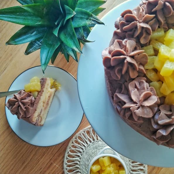 Pineapple gateau cake slice on a table.