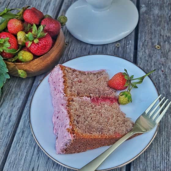 Slice of strawberry cake on a serving plate.